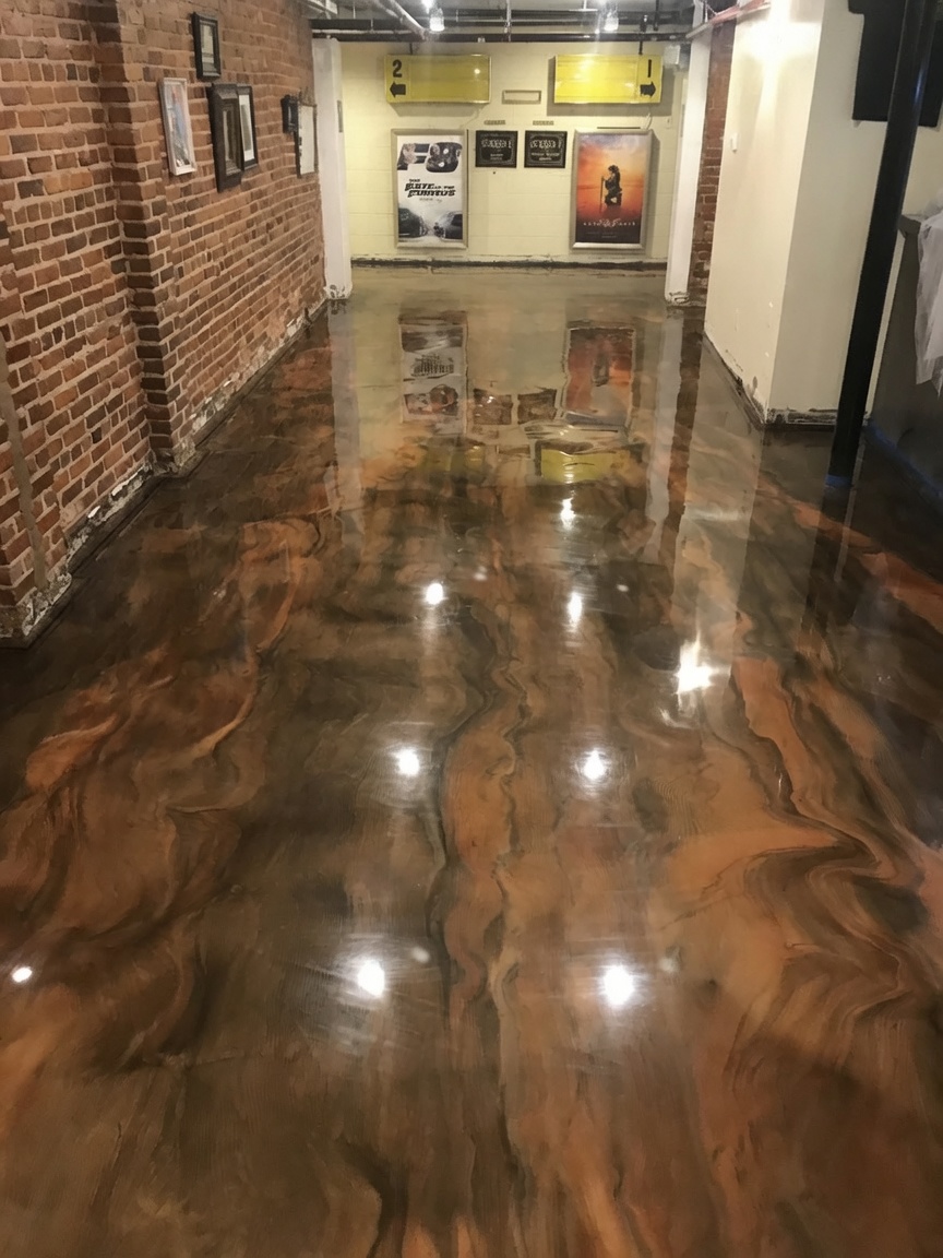 Copper metallic epoxy flooring in a commercial theater hallway in Savannah, GA
