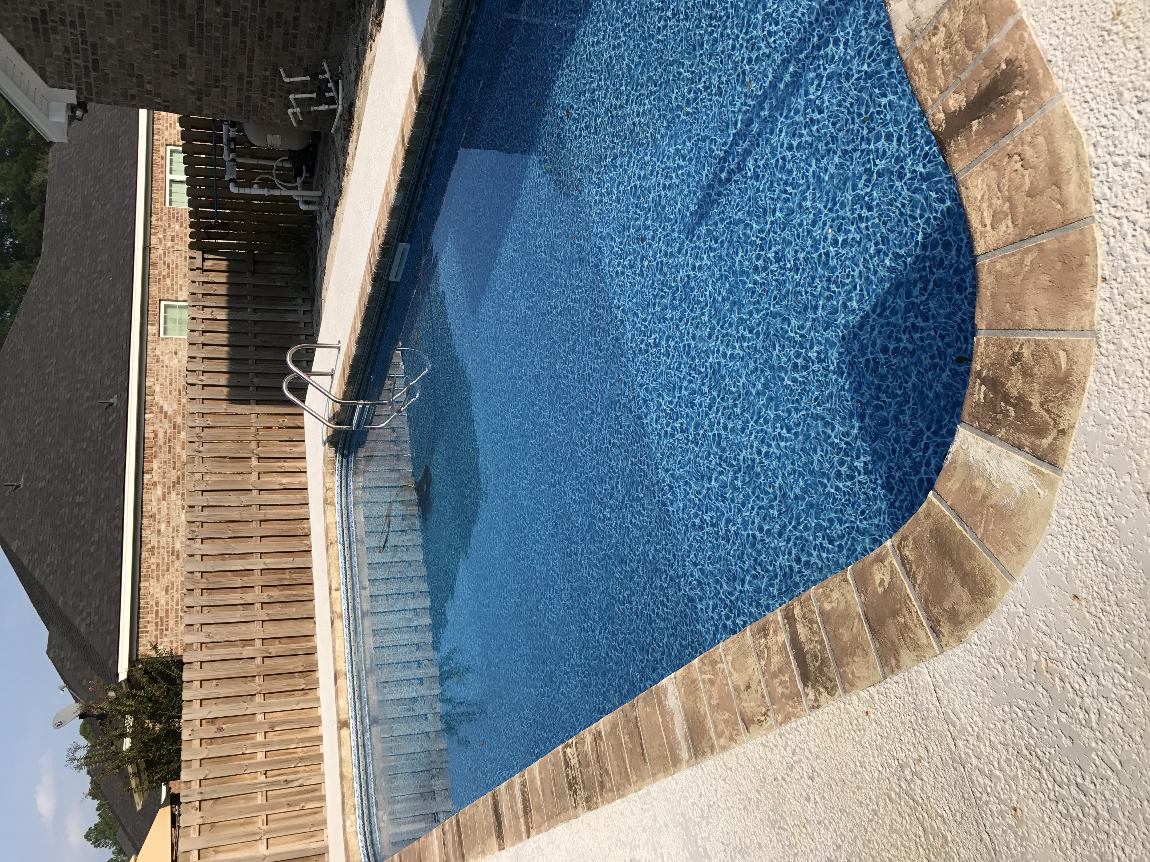 Pool deck concrete coating with stone border Savannah GA